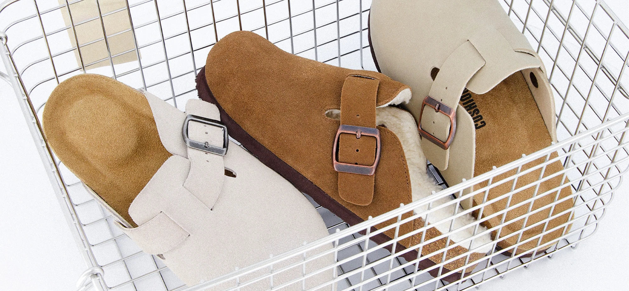 Suede clogs arranged in a white wire basket